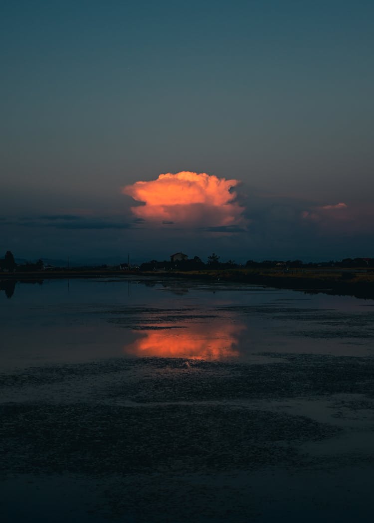 A Cloud Over A Lake At Dusk