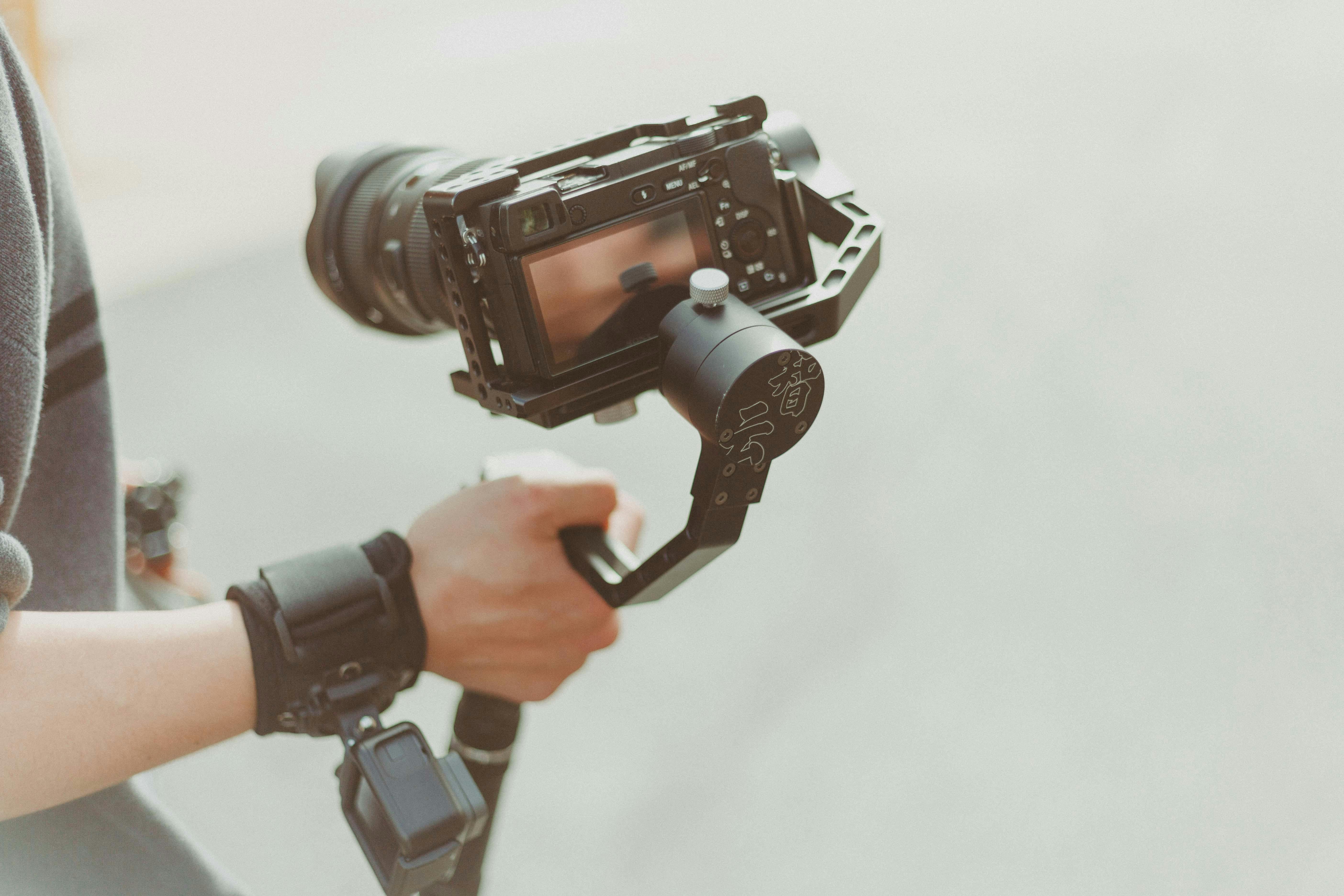 person holding black dslr camera