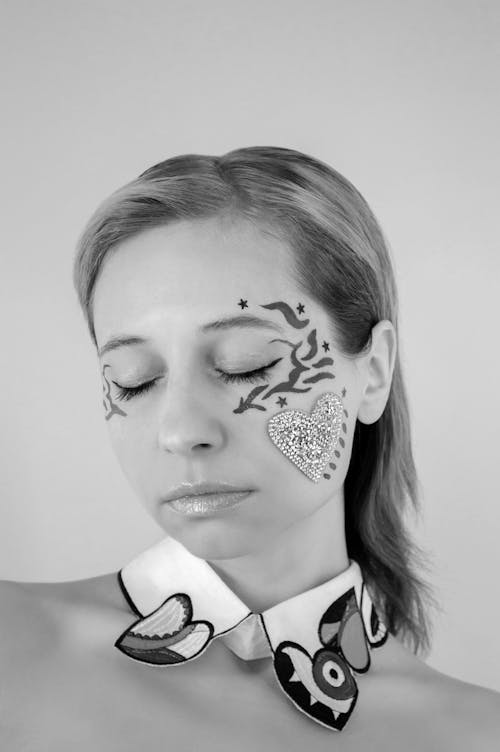Grayscale Photo of a Woman with Face Paint
