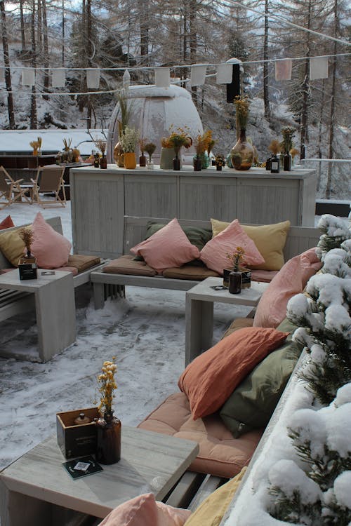 Free Pillows on Benches by Tables in the Snow Stock Photo