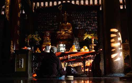 A Person Praying inside a Temple