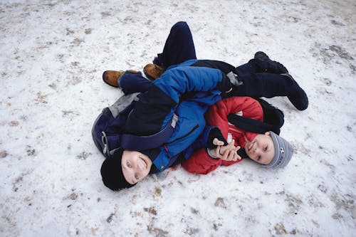 Photograph of Boys in Jackets Playing on the Snow