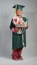 Woman in Green and Pink Dress Holding Bouquet of Flowers