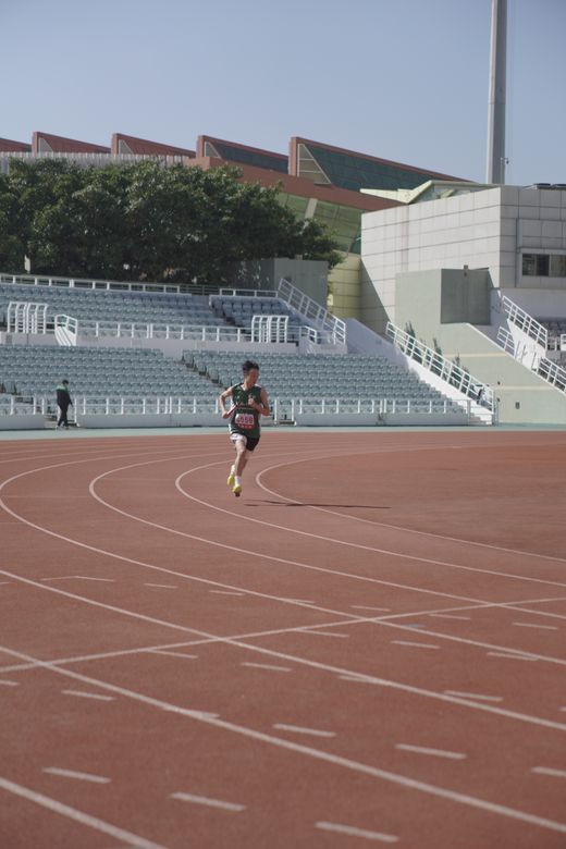 Runner on a stadium track — photo by Gary Chan on Pexels