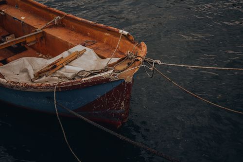 Free A worn boat anchored in İstanbul's serene waters, showcasing rustic charm and peaceful ambiance. Stock Photo