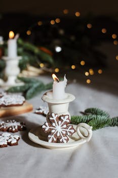 Festive candle with gingerbread and fir decor for a warm holiday feel.