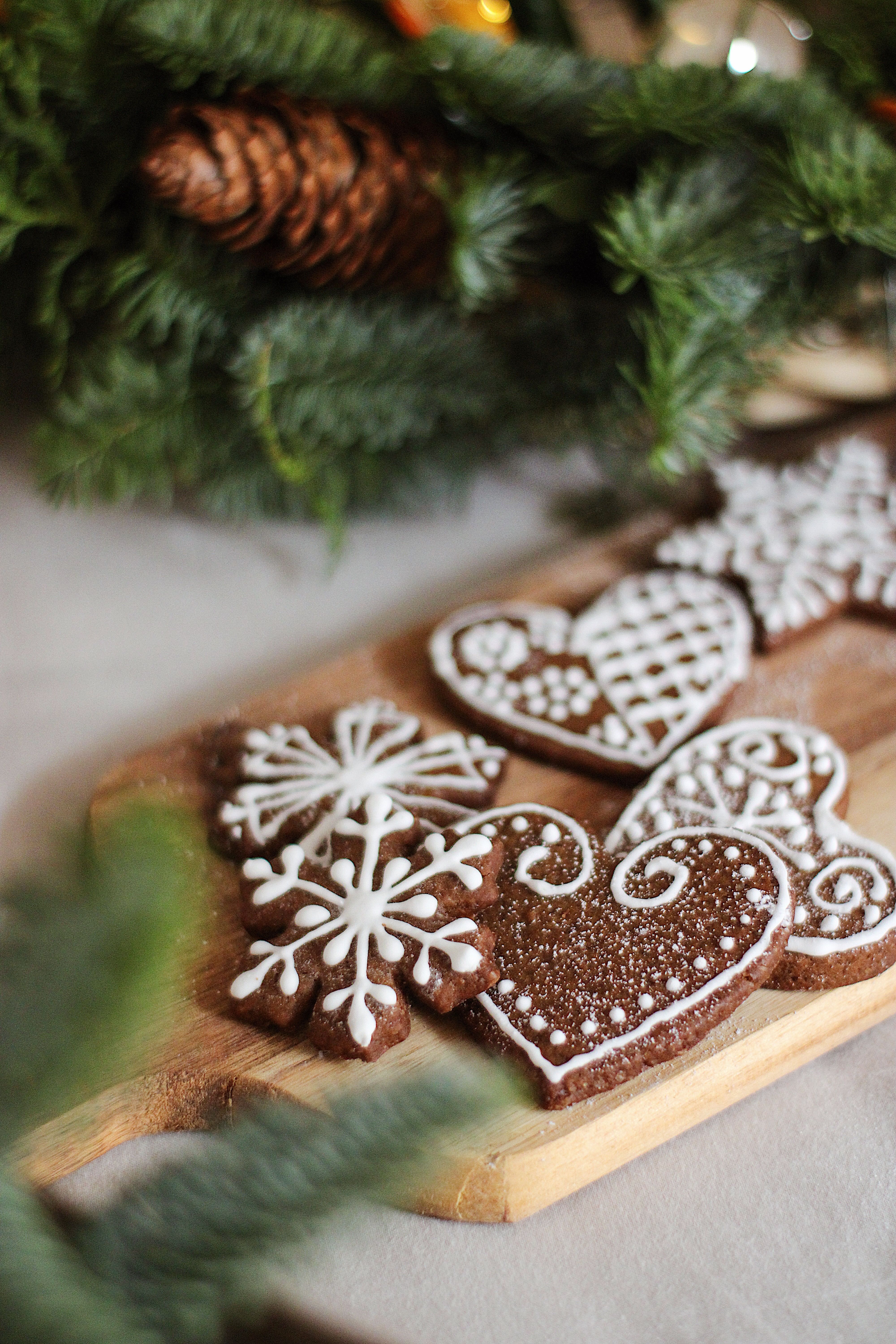 Decorative gingerbread cookies on a cutting board, perfect for Christmas celebrations.