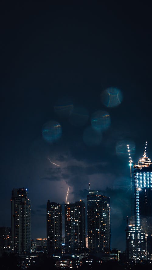 Free Captivating view of Jakarta skyline illuminated at night with lightning. Stock Photo