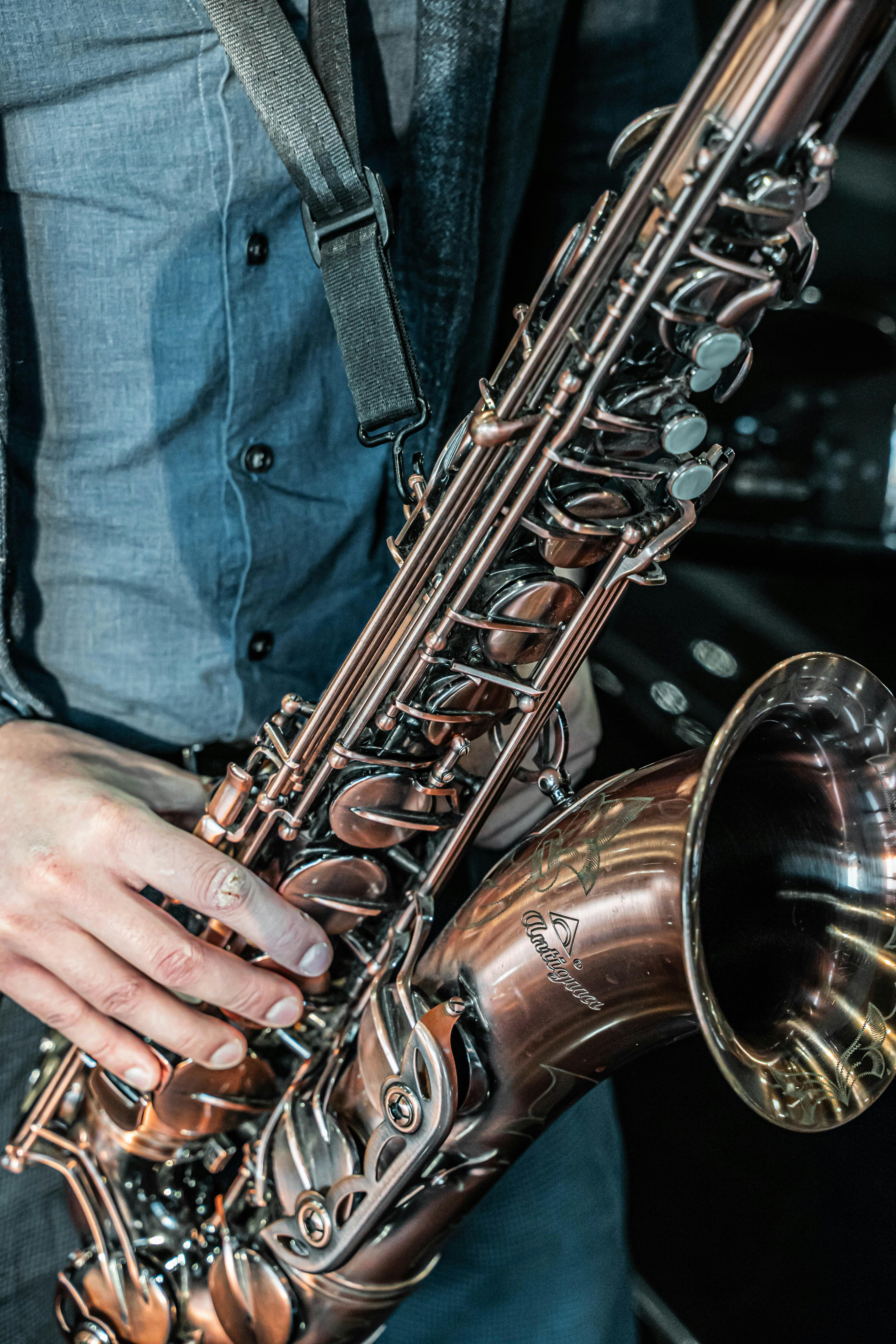 Golden saxophone with musical notes on wooden background, close up Stock  Photo - Alamy