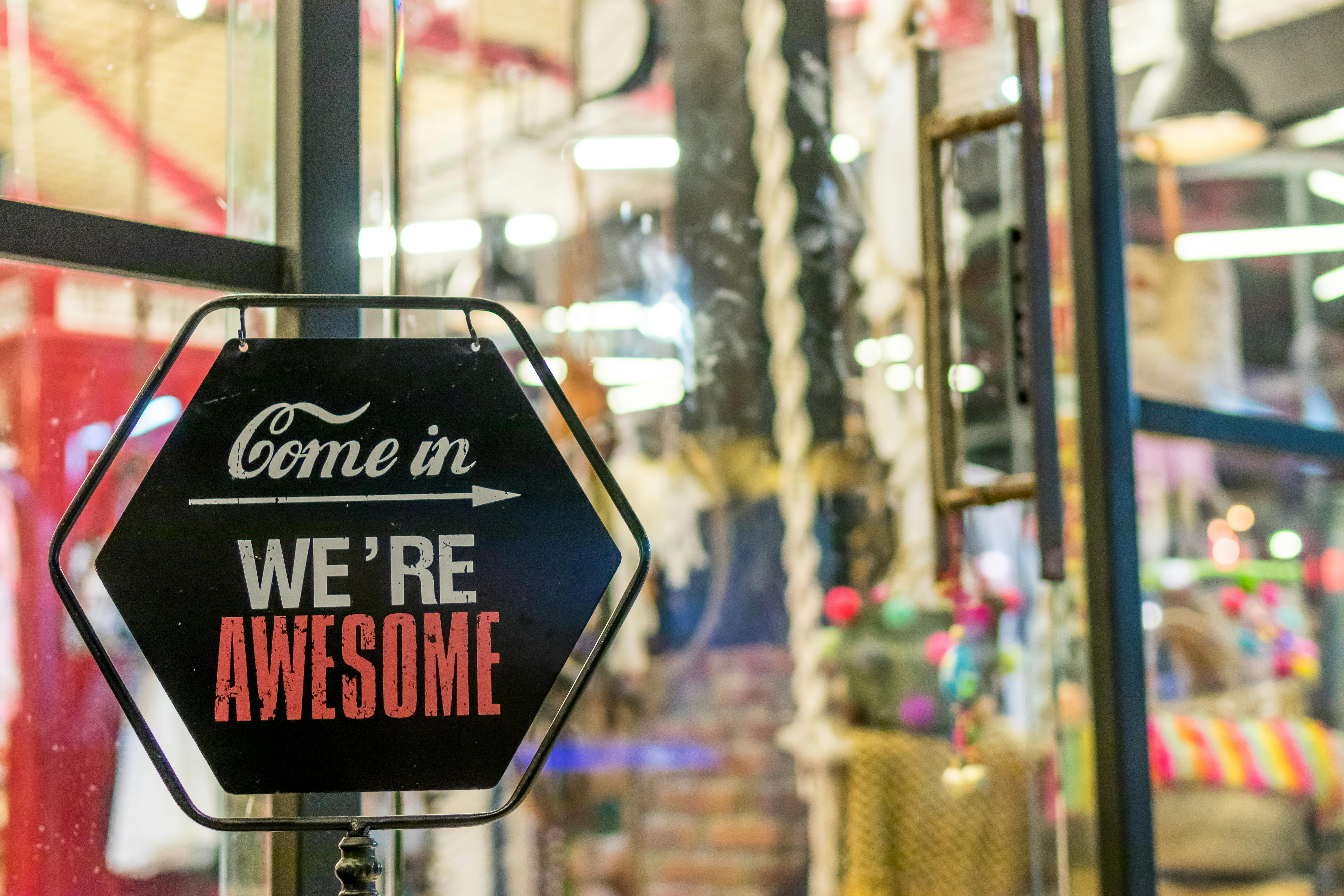"Come in we're awesome" sign at department store. | Photo: Pexels