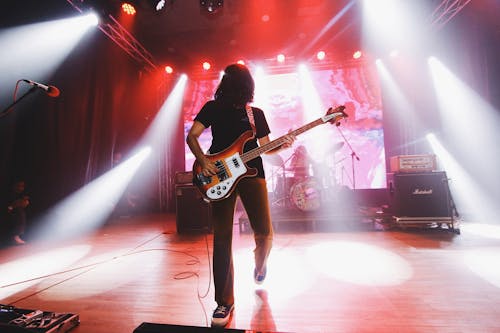A Man Playing the Electric Guitar on Stage