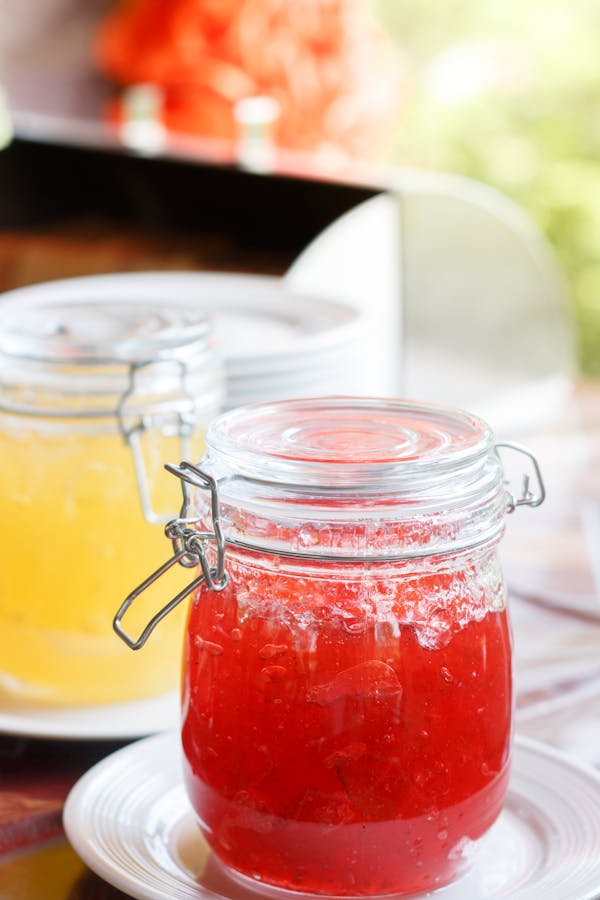 Jar With Red Jam on White Sauer