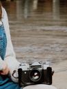 Person Holding a Vintage Black and Silver Camera