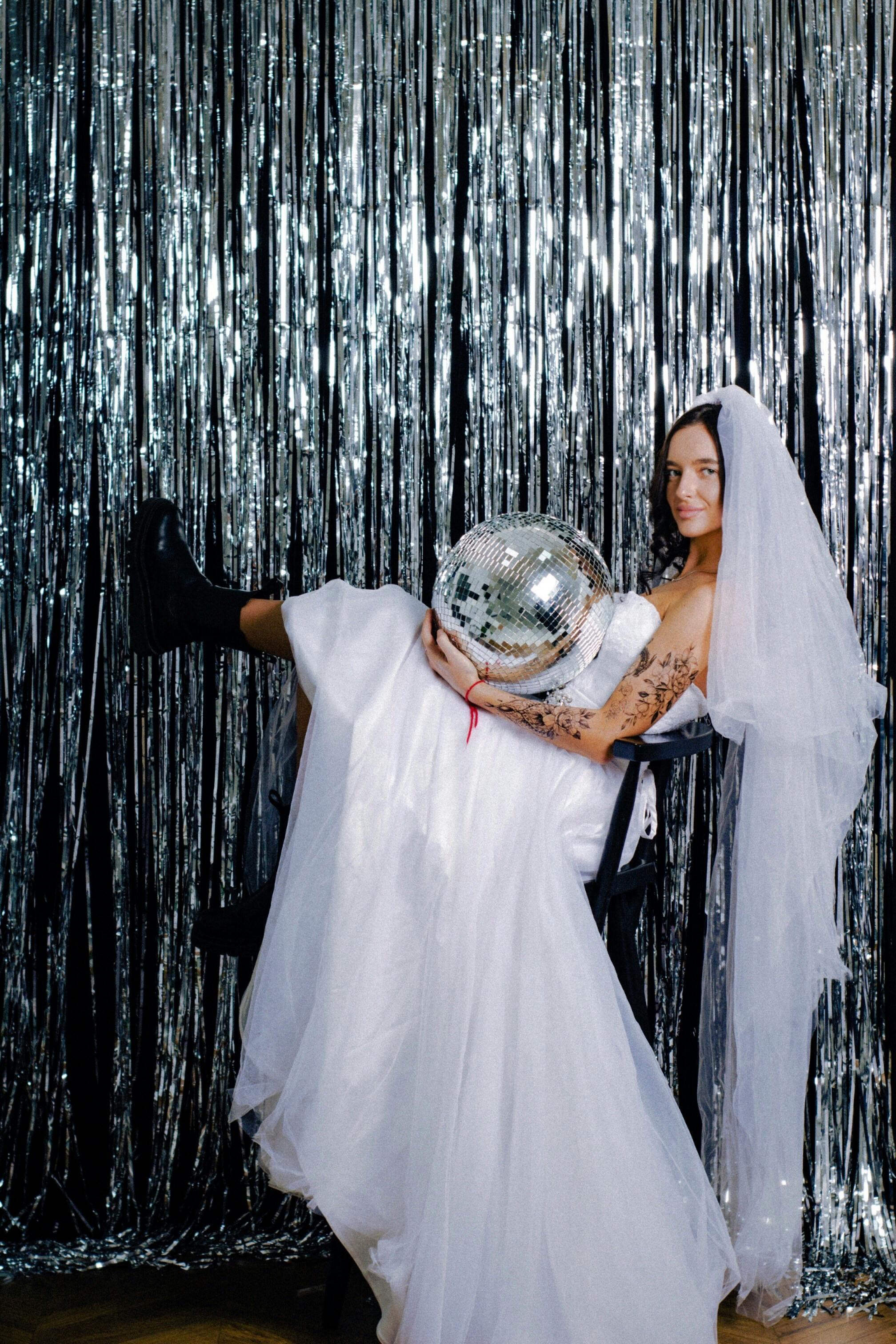 A Woman in a Wedding Dress Holding a Disco Ball Free Stock Photo A Woman in a Wedding Dress Holding a Disco Ball Free Stock Photo