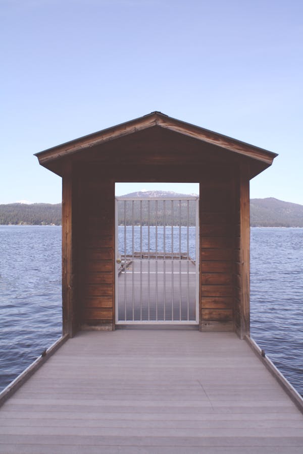 Brown Wooden Dock With White Metal Fence