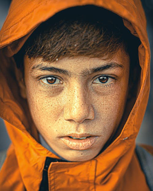 Boy in Orange Hoodie in Close Up Photography