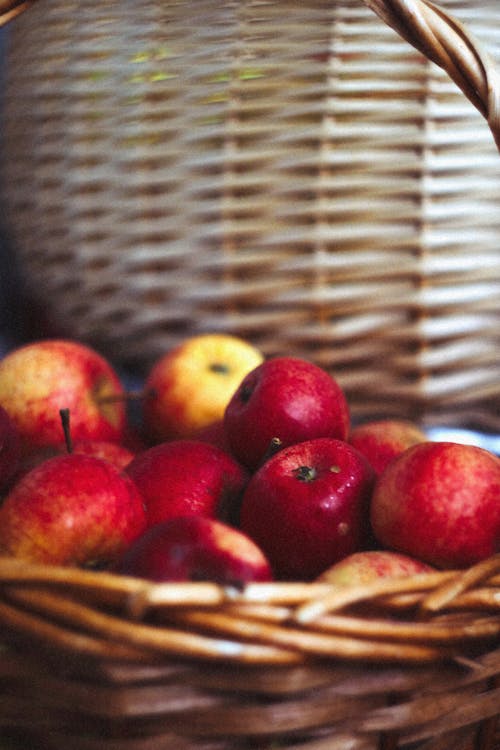 A Bunch of Red Apples on Brown Wicker Basket