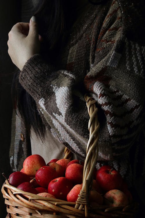 Woman in Black and White Scarf With Red Apple Fruit on Her Head