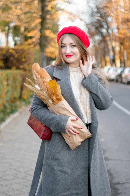 Free Woman in Gray Coat Holding Brown Paper Bag Stock Photo
