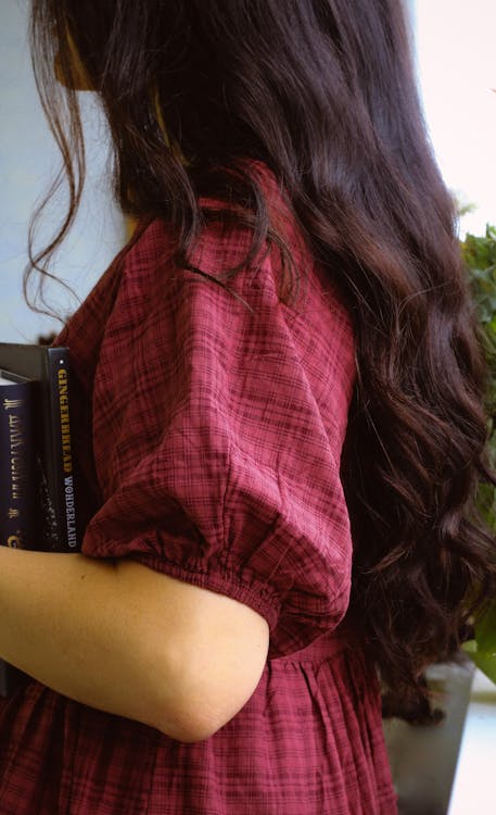 A Side View of a Woman in Red Plaid Dress