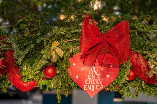 A vibrant Christmas wreath adorned with red bows and ornaments, perfect for holiday decoration.