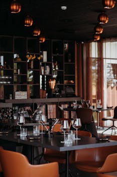 A chic and modern restaurant interior with stylish decor and mood lighting, set for dining.