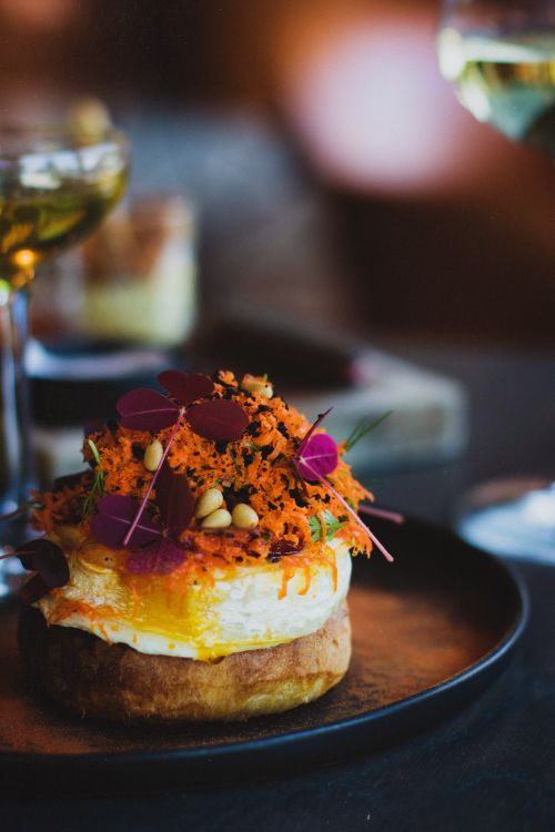 Free Elegant plated dish with edible flowers and creative presentation. Stock Photo