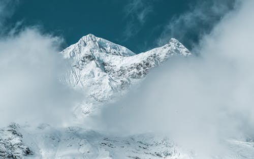 A Snow Covered Mountain Under the Blue Sky