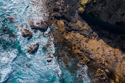 Bird's-eye view of Waves Crashing on Rocks