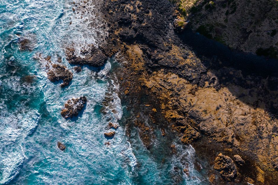 Stunning Victoria Falls : Scenic Day Tour, Lunch & Helicopter Flight Review Review 2026 - Dramatic bird's-eye view of Victoria's rugged coastline with crashing waves and rocky terrain.