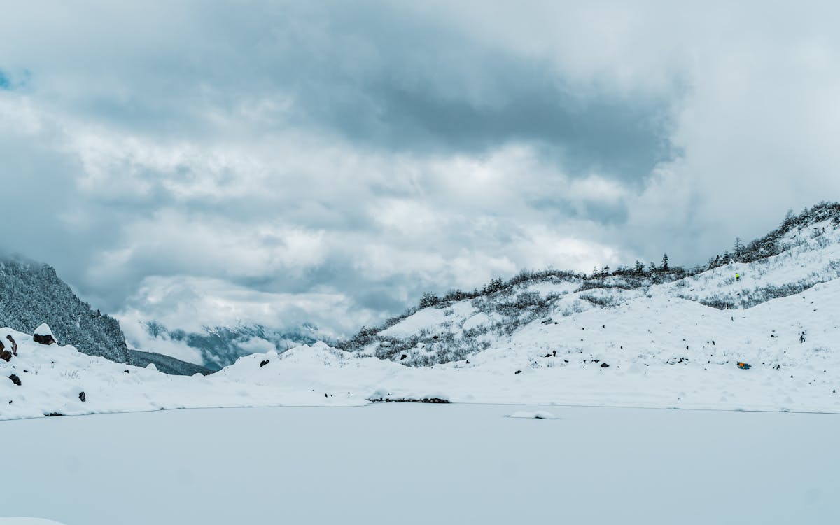 A Snow Covered Mountain Under the Cloudy Sky