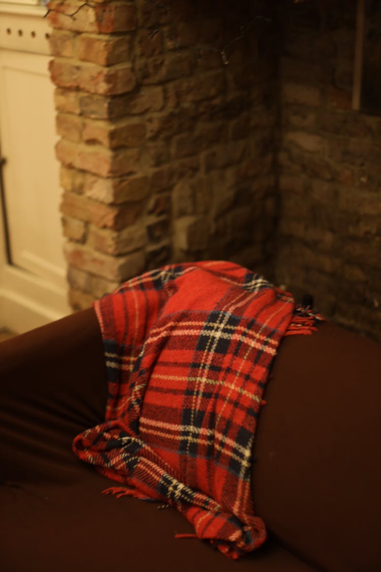 Plaid Scarf Over A Sofa