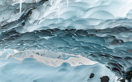 Icicles on Cave in Winter Landscape