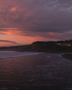 Enjoy a breathtaking view of Anglesea beach at twilight with a moody sky and serene sea.