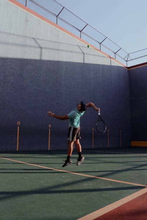 A Tennis Player Serving the Ball