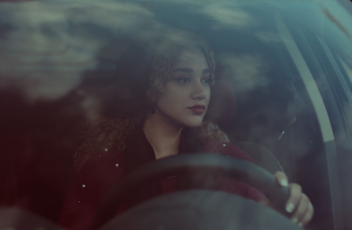 Woman looking through a Car's Window on the Driver's Seat · Free Stock ...