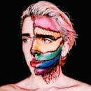 Person Wearing Artistic Makeup Depicting Scars and Rainbow Flag