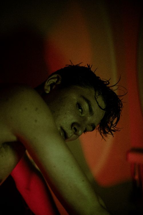 Free Moody close-up portrait of a shirtless man under red lighting, evoking dramatic and artistic vibes. Stock Photo