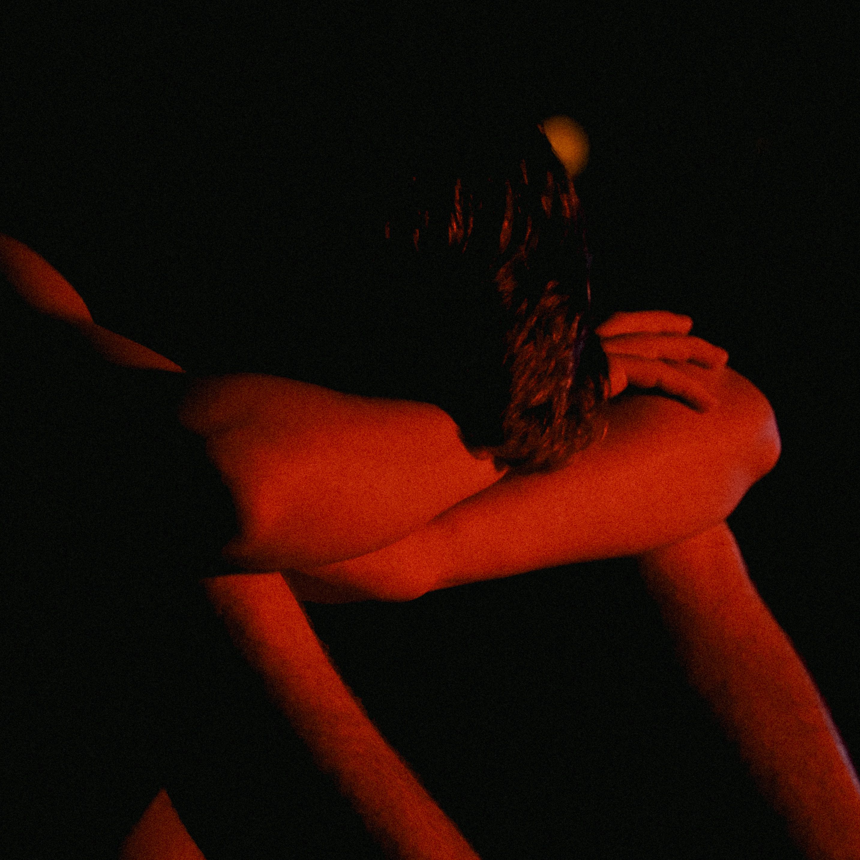 A Person Sitting Resting His Head on his Arms