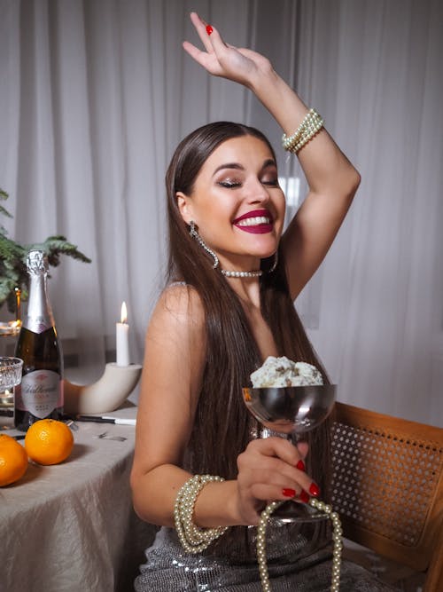 Carefree Woman holding a Silver Wine Cup 