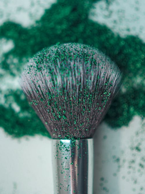 Makeup Brush with Green Pigment in a Macro Photography 