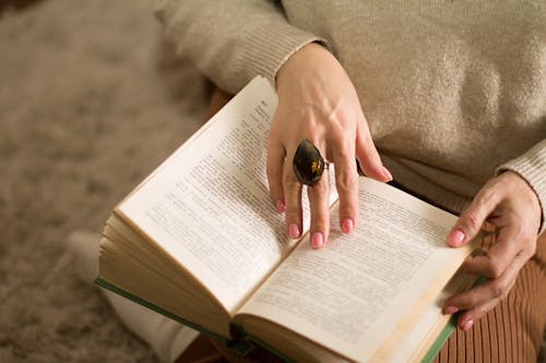Free Close-up Photo of an Opened Book held by a Person  Stock Photo
