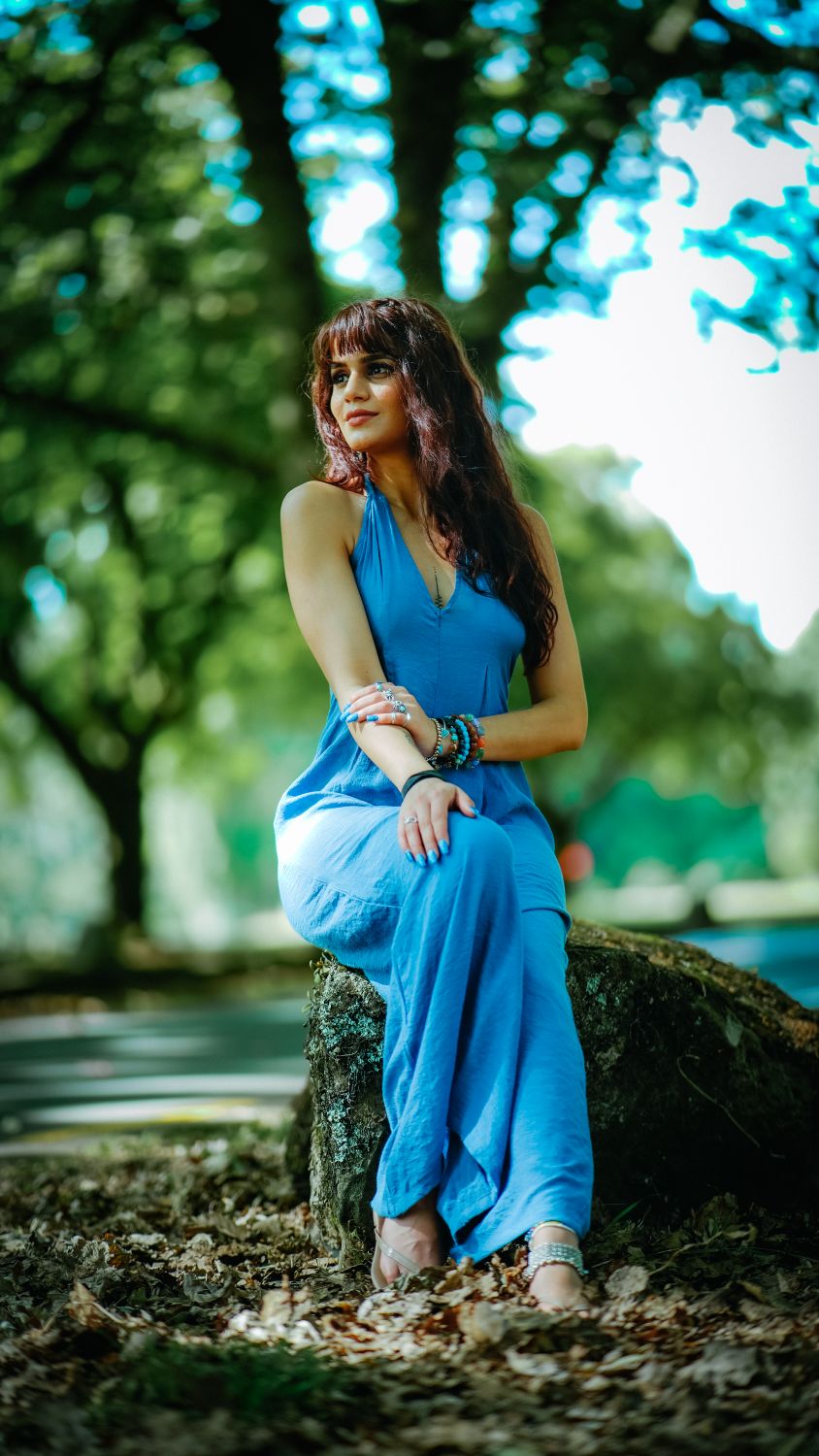 Beautiful Woman in Blue Dress sitting at Top of the Rock · Free Stock Photo
