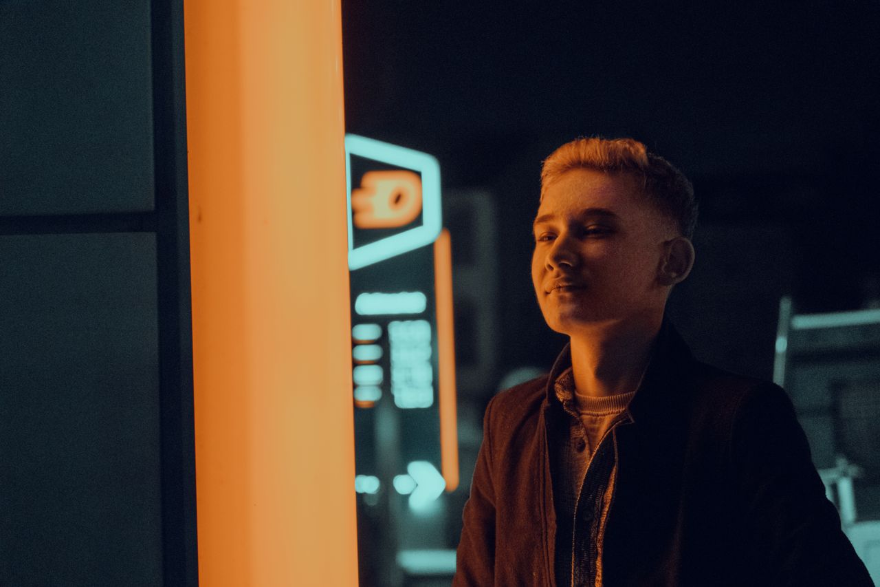 portrait of a young man under neon lights in fethiye t rkiye