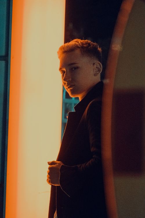 Free Artistic portrait of a young man with vibrant night lighting in Fethiye, Turkey. Stock Photo