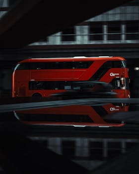 Vibrant red double-decker bus on a London street, classic city scene.