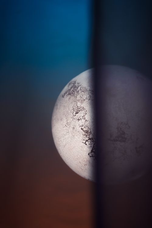 Free A creative view of the full moon through a curtain with an artistic focus effect. Stock Photo