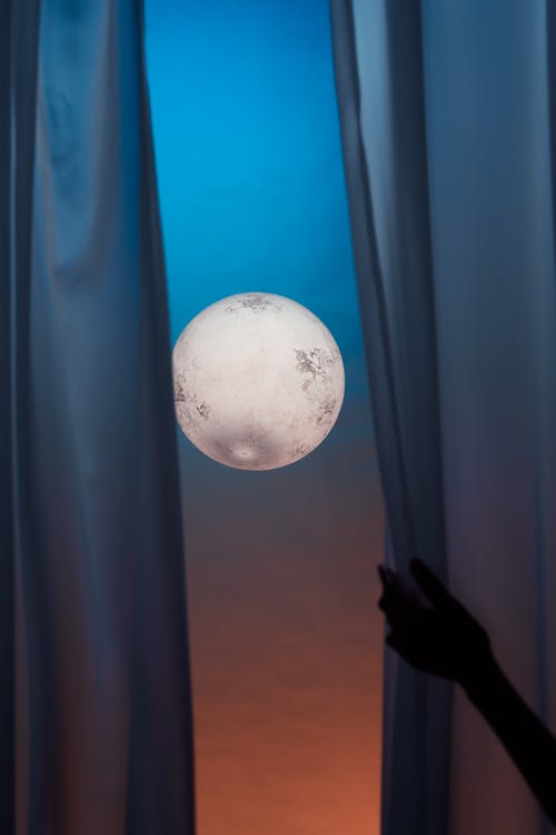 Free Full Moon and Hand Holding Curtain  Stock Photo