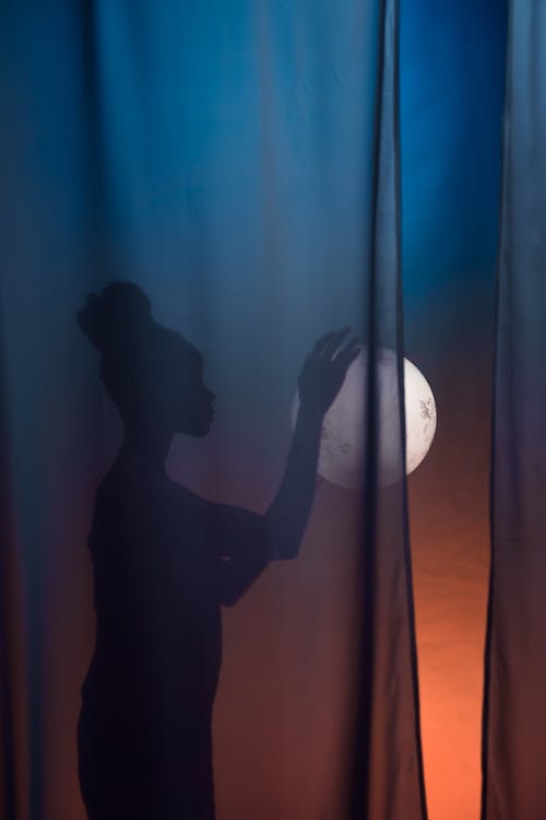 Free Silhouette of Woman Behind Curtain and Full Moon Stock Photo
