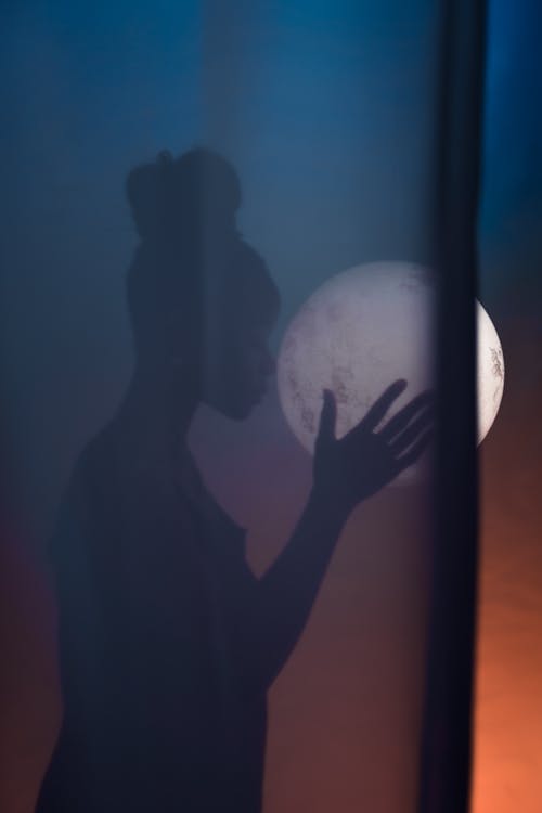 Free Silhouette of Woman Holding Moon Stock Photo